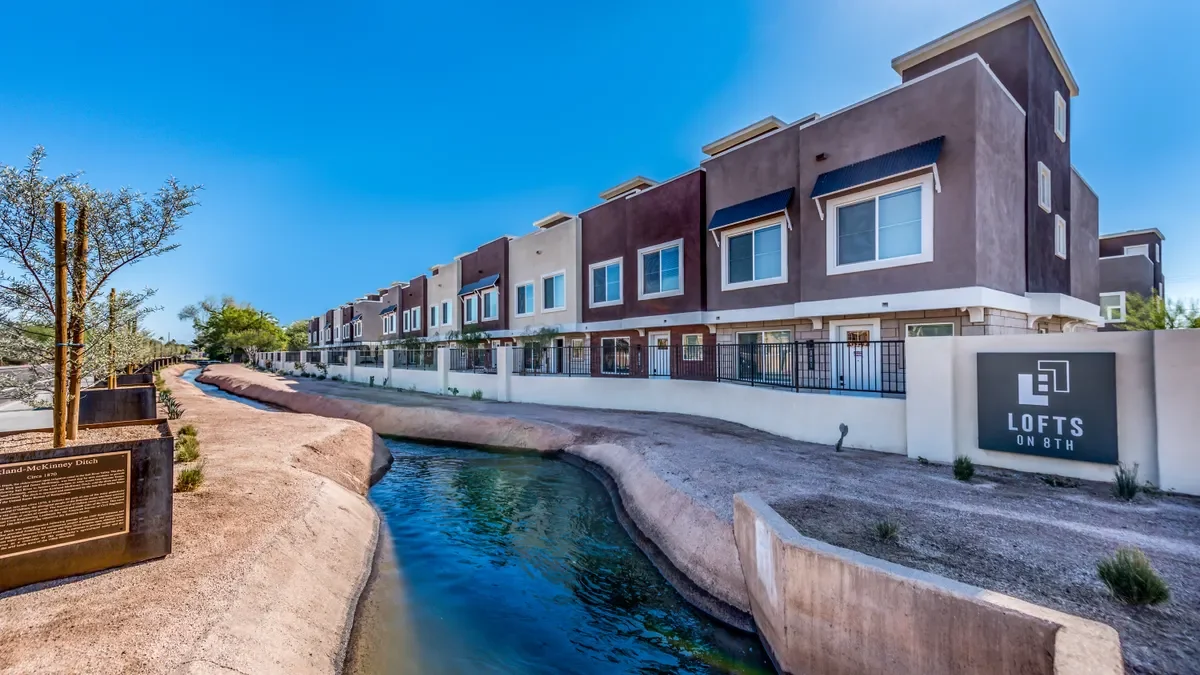 Student housing with a canal in the foreground.