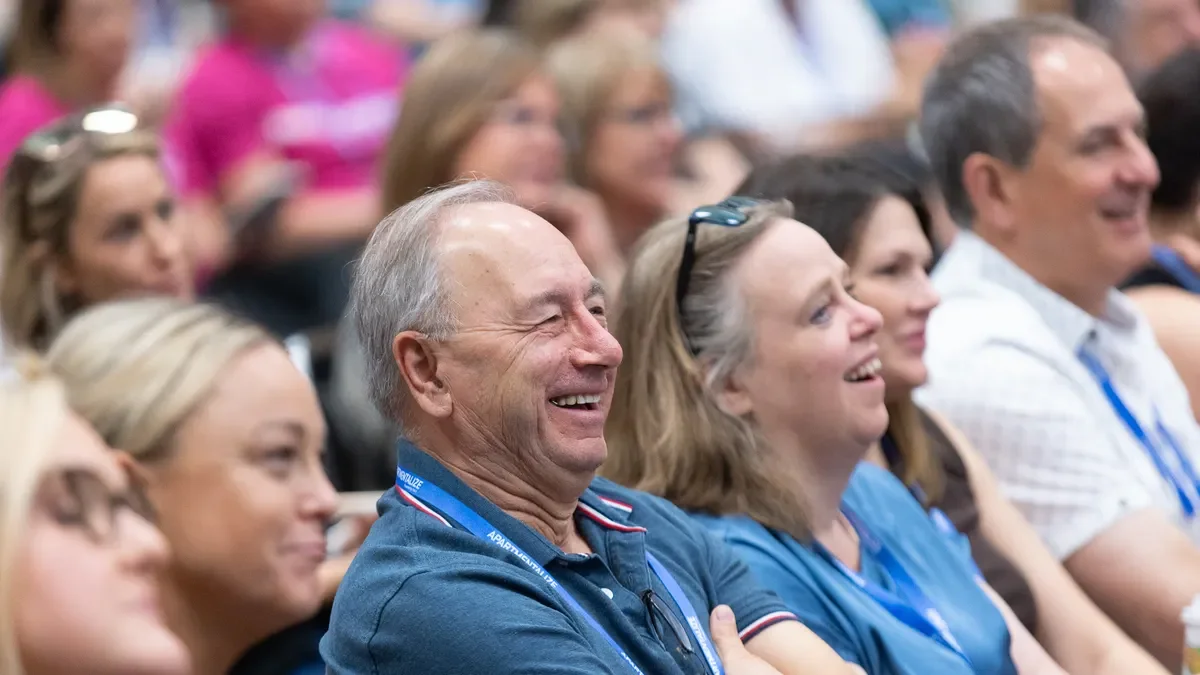 Attendees listen at a conference.
