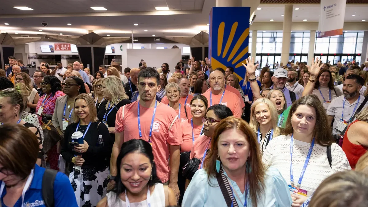 Attendees walk in the hallways at a conference.