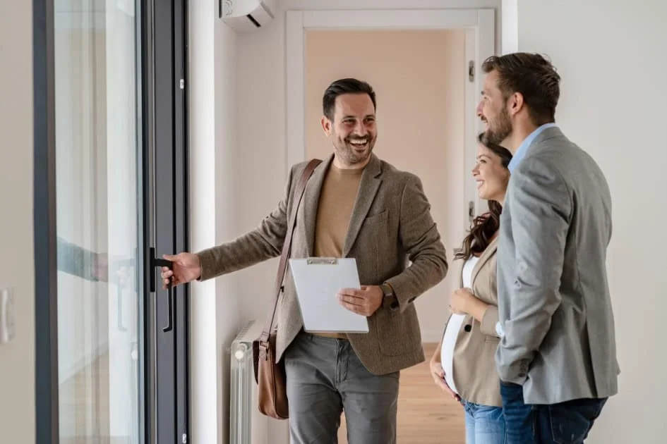 How many houses do people look at before buying? Couple touring a home with a real estate agent.