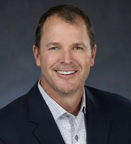 Headshot of a man in a suit.