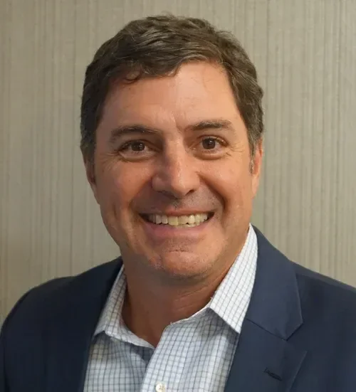 Headshot of a man in professional attire.