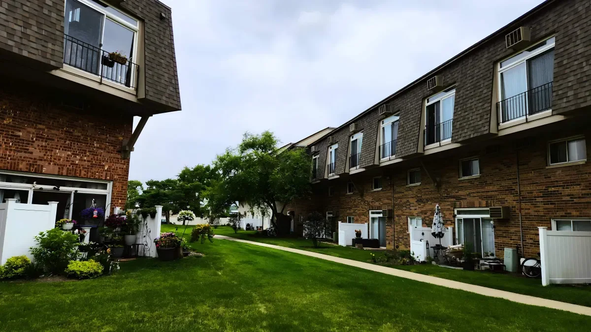 Two-story brick garden-style apartments with brown roof